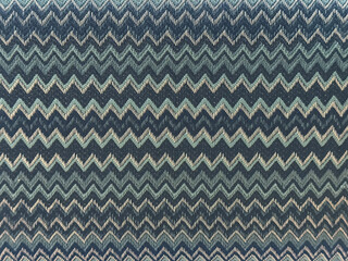 Close up of blue color fabric in repetitive chevron pattern. Shades of blue color chevron zigzag...