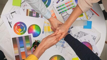 Group of architects, creative interior designers team members meeting in boardroom at desk, discuss design project of new house, close deal shake hands, top view.