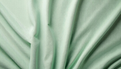 Fototapeta premium Light green fabric with gathered folds and smooth texture 