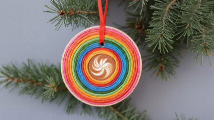 Rainbow ornament hanging on Christmas tree