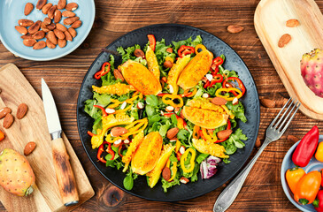 Salad of cactus fruits, peppers and almonds.