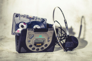 Cassette inside a walkman with its headphones. portable music player from 80s and 90s