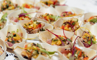 close up view of a small portion of healthy food in a bamboo plate on a table at an even 