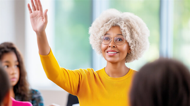 Elderly teacher enthusiastically engaging with her students in a bright classroom. Her gesture and smile reflect passion for teaching and a supportive learning environment.