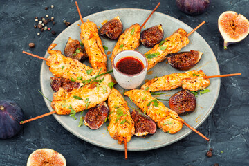 Grilled chicken on bamboo skewers.