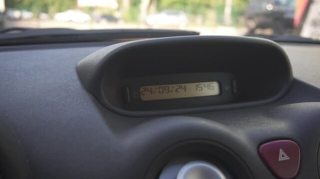 Information display with clock on the dashboard of the car