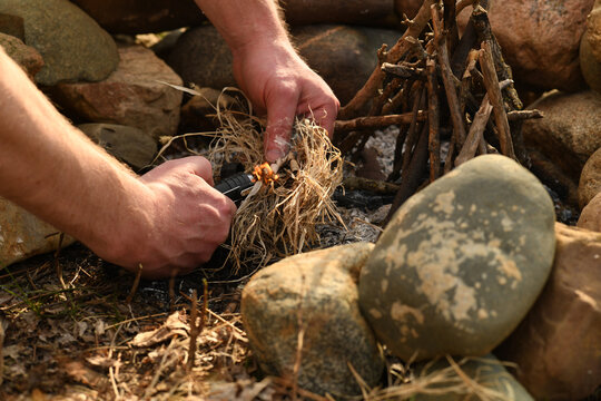 Lighting camp fire with plasma arch torch lighter in nature - Powered by Adobe