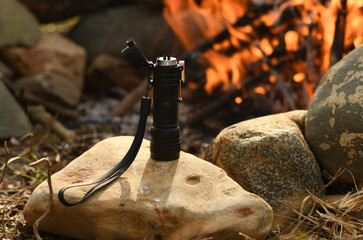 Lighting camp fire with plasma arch torch lighter in nature