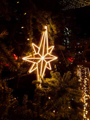 Christmas tree with illumination lights in city square