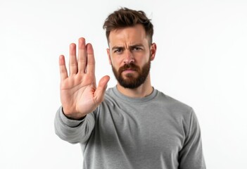 Man with beard holding up his hand in a stop gesture