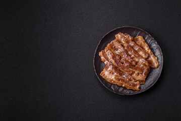 Crispy fried pork bacon sliced with salt, spices and herbs