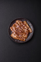 Crispy fried pork bacon sliced with salt, spices and herbs