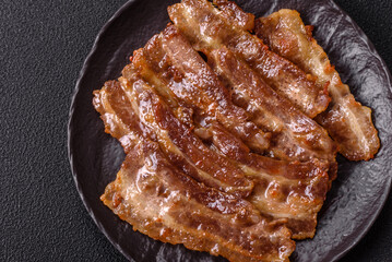 Crispy fried pork bacon sliced with salt, spices and herbs