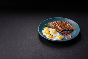 A hearty, delicious breakfast with fried eggs, bacon and tomatoes