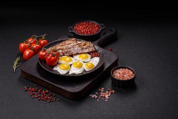 A hearty, delicious breakfast with fried eggs, bacon and tomatoes