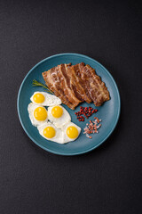 A hearty, delicious breakfast with fried eggs, bacon and tomatoes
