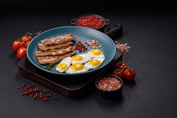 A hearty, delicious breakfast with fried eggs, bacon and tomatoes