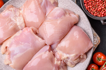Fresh raw chicken thigh fillets with salt, spices and herbs