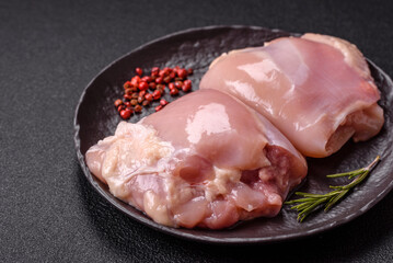 Fresh raw chicken thigh fillets with salt, spices and herbs