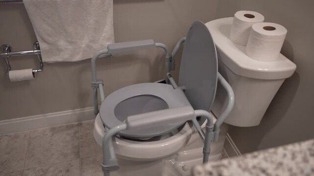 A bathroom features an accessible toilet with grab bars, designed to assist individuals with mobility challenges, ensuring safety and comfort.