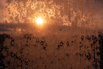 frosty drawing on the loggia window shows the city through the ice