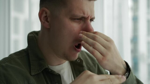 A man covers his nose from an unpleasant smell.
The man shows with all his appearance that he stinks very much.
Unpleasant smell in the room.
Strong and unpleasant odor.
Ventilation of the room