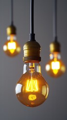 Three vintage-style light bulbs glowing warmly in a modern setting.