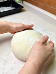 woman's hands kneading dough, baking, pizza dough