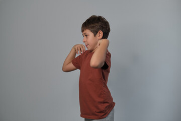 A young boy strikes a playful pose, showing energy and creativity. His lively expression adds to the cheerful atmosphere.