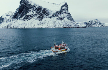 A Fishing Boat Navigating Through a Stunningly Snowy Arctic Landscape in Wintertime