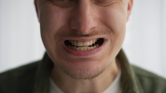 Mouth facial expressions.
A man warms up his speech apparatus.
Massage your mouth before a performance.
Oratory art.
The announcer stretches his mouth for clear diction