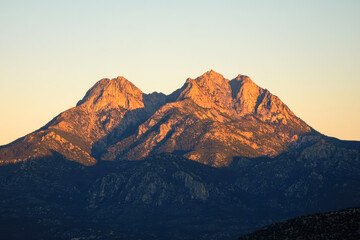 Majestic sunset over rugged mountain peaks in golden light