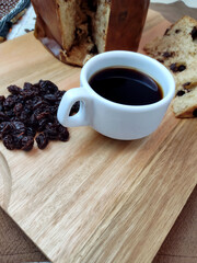 Coffee cup, raising and italian raisins cake on the wooden table. Rustic atmosphere.