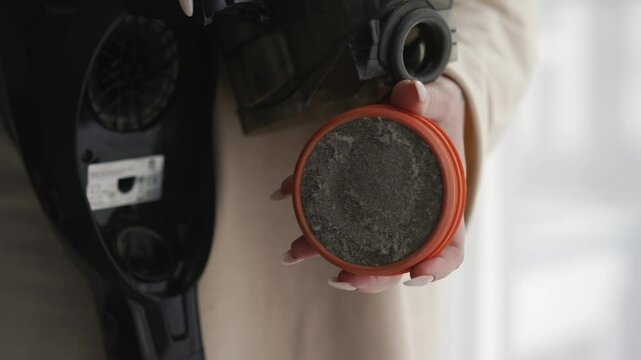 Cleaning the apartment.
A vacuum cleaner is in the hands of a girl.
A clogged paralon filter in the hands of a girl.
Disassembled vacuum cleaner in hands