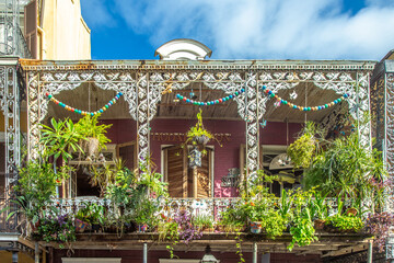 historic building in the French Quarter in New Orleans with typical iron balcony and plants in the...