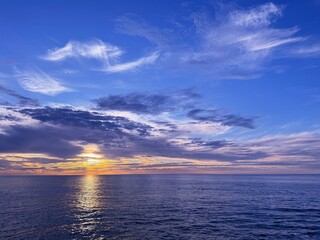 Dusk sky clouds and shiny ocean 
