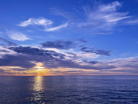 Dusk sky clouds and shiny ocean 