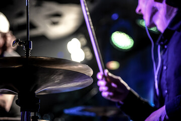 Man play drum kit, musician drummer performs at concert in nightclub bar