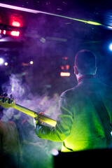Man play strings guitar, musician guitarist performs at concert in nightclub bar