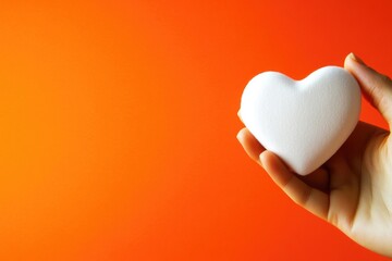 A person holding a symbol of love and kindness