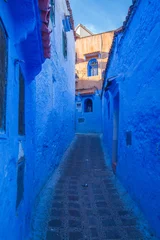 narrow alleyway between blue-washed buildings, creating a strong sense of depth and perspective.