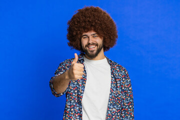 Like. Caucasian stylish man raises thumbs up agrees with something gives positive reply recommends...