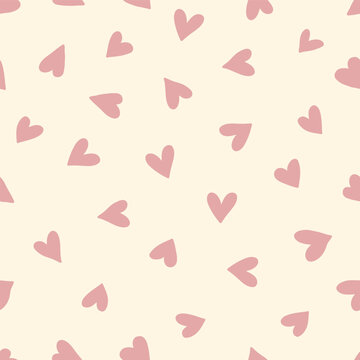 Seamless pattern design with colorful hearts in boho style. Simple abstract texture. Romantic background. Great for fabric, textiles, and apparel. Soft pink and beige colors. Vector illustration