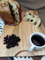 Raisins, coffee cup and italian raisins cake on the wooden tray. Rustic atmosphere.
