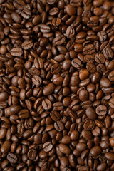 Top view closeup roasted coffee beans. Vertical copy space background, cover, backdrop, texture. Place for adding text or design