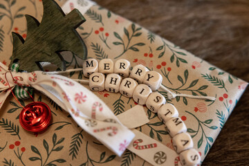 Christmas present with wooden merry christmas letters