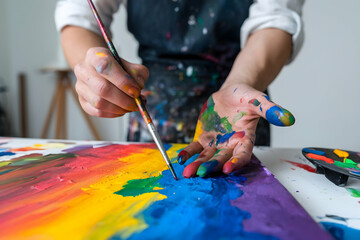 Naklejka premium Paint Stained Hands in Creative Artistic Process