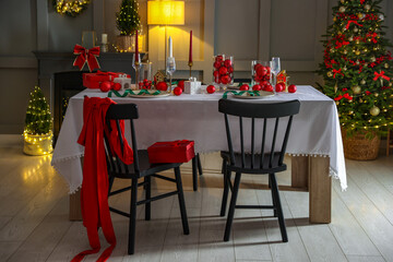 Christmas celebration. Festive table setting with dishware, glasses and decor