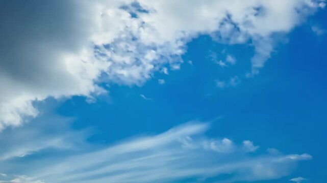 Beautiful blue sky with clouds on bright sunny day for abstract background. White clouds moving towards the horizon.
