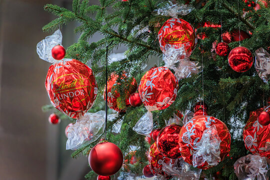 Iconic Lindt Christmas tree with red chocolate decorations, Zurich Hauptbahnhof